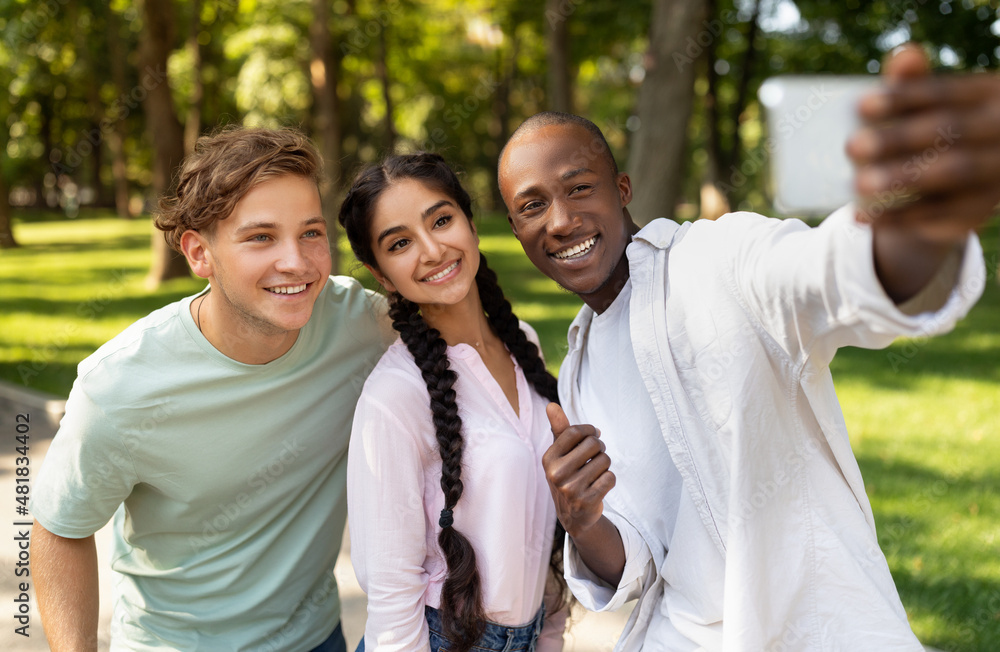 Capturing moments. Cheerful african american student guy taking selfie with his university friends in campus Capturing moments. Cheerful african american student guy taking selfie with his university friends in campus