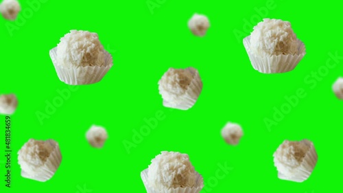 Raffaello balls with almonds and condensed milk inside and covered with coconut shavings flying and wiggle on green screen background. Love template valentine's day gift. Professional motion design 4k photo