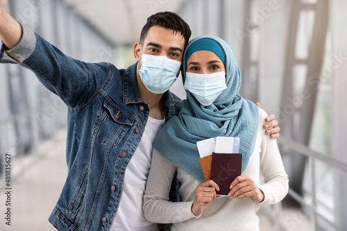 Happy Islamic Spouses In Medical Face Masks Taking Selfie In Airport
