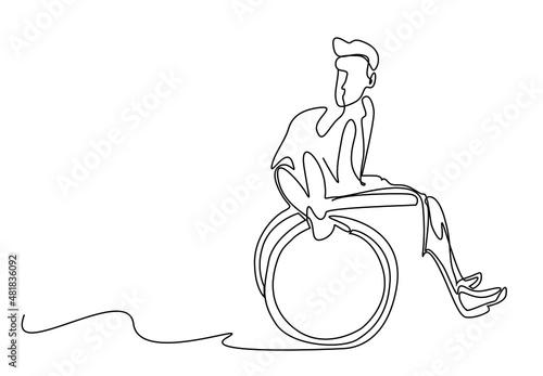 disabled person driving wheelchair looking behind