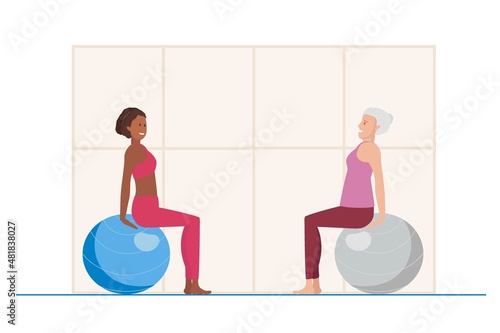 Elderly woman takes lessons of Exercises with fitball. Young African American giving sports lesson. Females doing pilates stretching training, follow healthy lifestyle. Exercises for elderly.