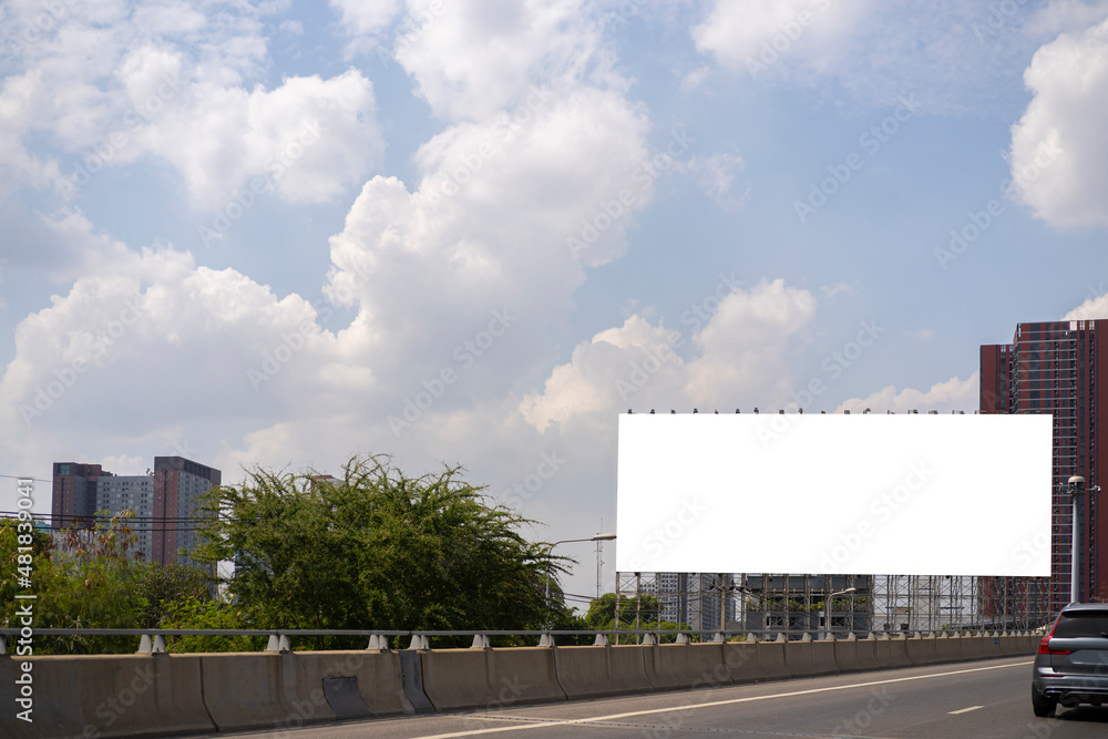 Empty white horizontal billboard on the roadside.