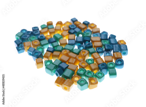 Pile of blue and yellow beads on white background
