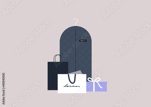 Elegant fashion boutique shopping, clothes packed in boxes, bags, and protecting suit covers
