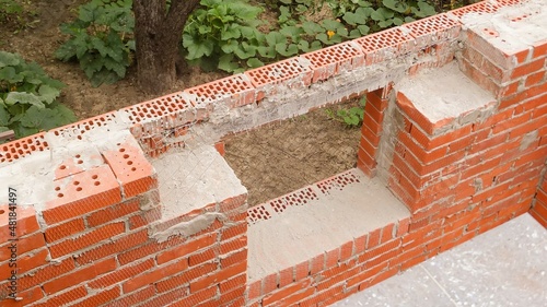 Place for installing reinforced concrete window lintel in country house under construction. Close-up. External facing brickwork above window is made on reinforced metal corner.