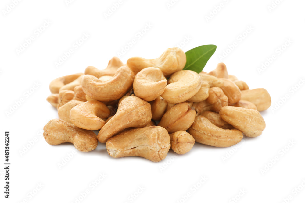 Pile of tasty organic cashew nuts and green leaf isolated on white Pile of tasty organic cashew nuts and green leaf isolated on white
