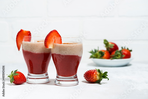 sweet strawberry yoghurt milkshake in glasses on white table