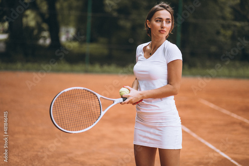 Young woman tennis player at the court © Petro