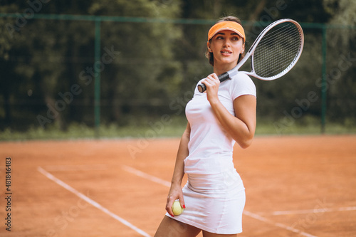 Young female tennis player at the court © Petro