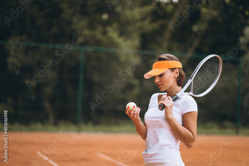 Young female tennis player at the court © Petro