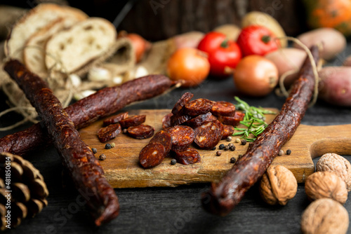 Smoked, aged sausages with fresh vegetables and food ingrediets
