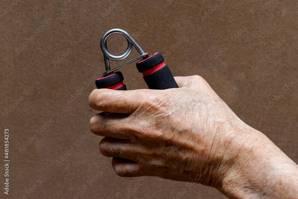Fototapeta premium Hand of Asian, Chinese old man gripping hand exercise gripper.
