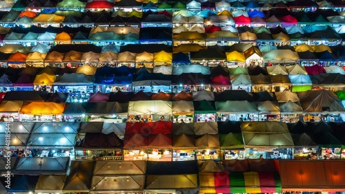 Wallpaper Mural Zoom out time lapse view of colourful food stalls at the popular Ratchada Night Market in Bangkok, Thailand.  Torontodigital.ca