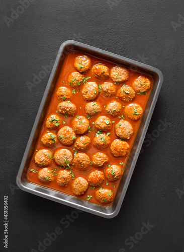 Meatballs with tomato sauce in baking dish