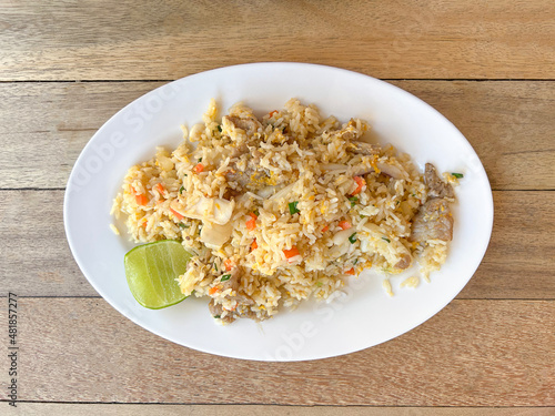 Fried rice with lemon on white plate