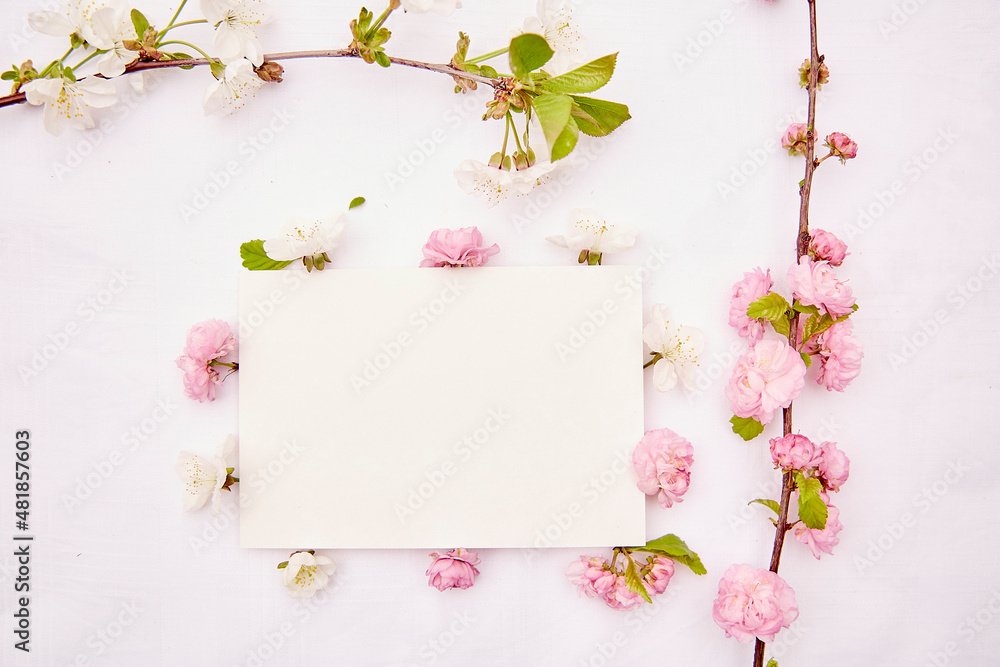 Feminine delicate stationery card mockup with spring white and pink flowers. Romantic, wedding, birthday, invitation, mother's day mock up card concept. Copy space. View from above Feminine delicate stationery card mockup with spring white and pink flowers. Romantic, wedding, birthday, invitation, mother's day mock up card concept. Copy space. View from above