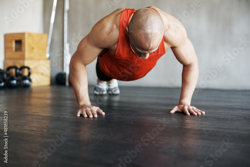 Training like a beast. Shot of a man doing pushups at the gym.