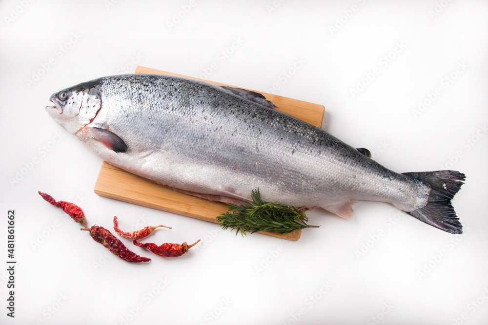 A whole salmon carcass on a chopping board. Red fish delicacy A whole salmon carcass on a chopping board. Red fish delicacy
