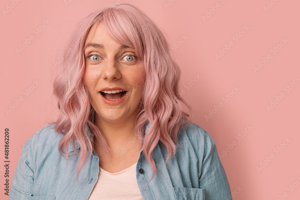 Shocked, surprised pink hair young pretty woman looking at camera on pink pastel background Shocked, surprised pink hair young pretty woman looking at camera on pink pastel background