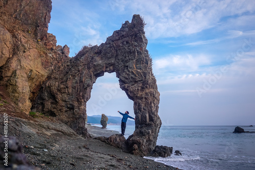 The traveler at the arch rock at Cape Giant