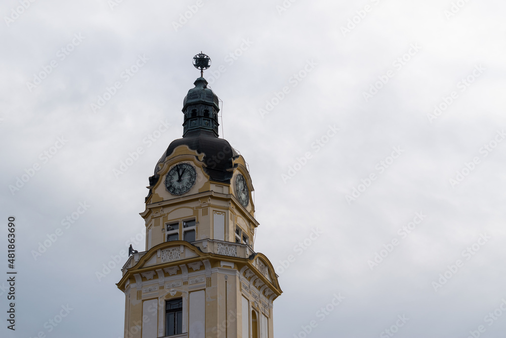 Clock tower with beautiful ornamental facade, detail from city assembly building in city of Pecs, Hungary