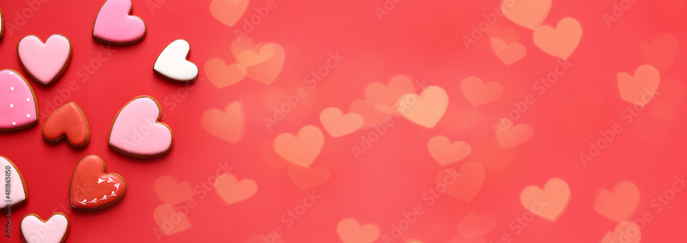 Tasty heart shaped cookies on red background with space for text