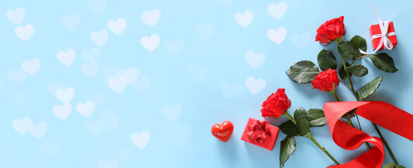 Beautiful roses and presents for Valentine day on blue background with space for text