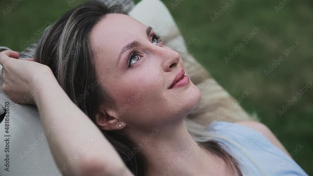 beautiful girl lies and looks at the camera beautiful girl lies and looks at the camera