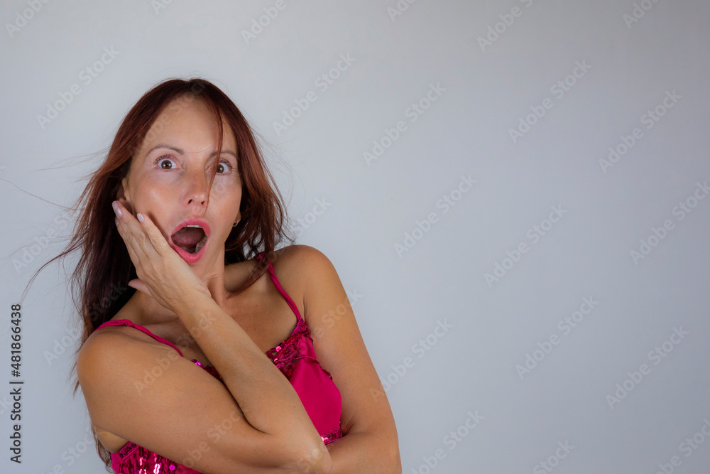 portrait of a woman with long hair and a surprised expression on a light background portrait of a woman with long hair and a surprised expression on a light background
