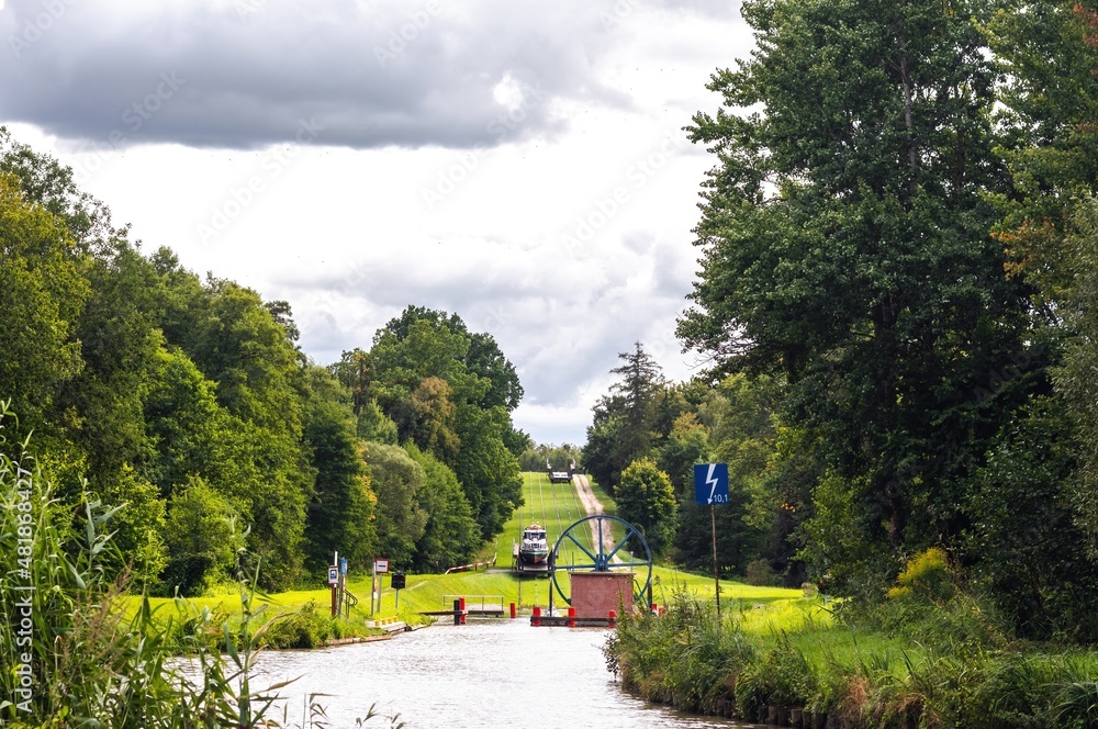 Green nature of the Elbląg Canal (Kanał Elbląski), famous landmark of Warmian-Masurian, Poland. Boat hauled on the link cradle up the inclined plane to overcome the difference in water levels.