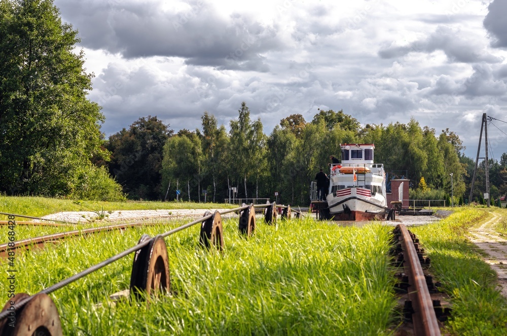 Green nature of the Elbląg Canal (Kanał Elbląski), famous landmark of Warmian-Masurian, Poland. Boat hauled on the link cradle up the inclined plane to overcome the difference in water levels.