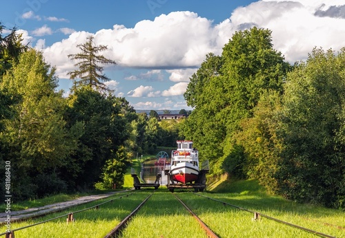 Obraz na płótnie Green nature of the Elbląg Canal (Kanał Elbląski), famous landmark of Warmian-Masurian, Poland. Boat hauled on the link cradle up the inclined plane to overcome the difference in water levels. w salonie