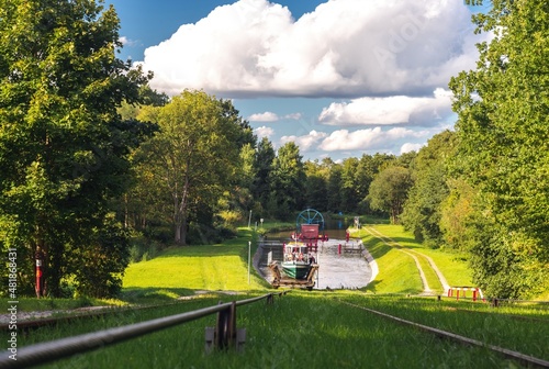 Obraz na płótnie Green nature of the Elbląg Canal (Kanał Elbląski), famous landmark of Warmian-Masurian, Poland. Boat hauled on the link cradle up the inclined plane to overcome the difference in water levels. w salonie