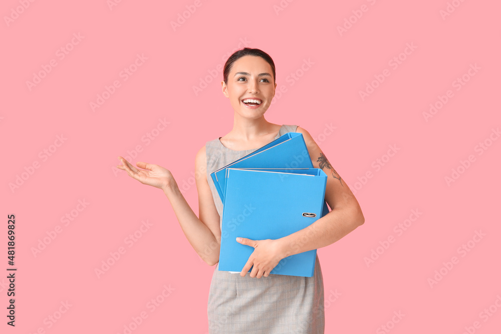 Beautiful young woman with folders on color background Beautiful young woman with folders on color background
