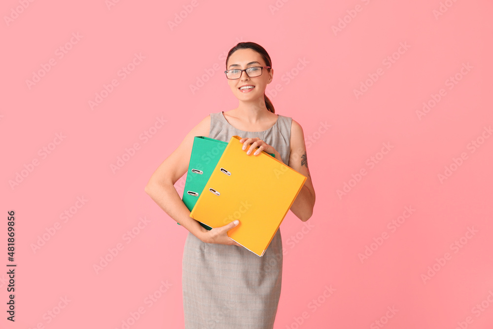 Beautiful young woman with folders on color background Beautiful young woman with folders on color background