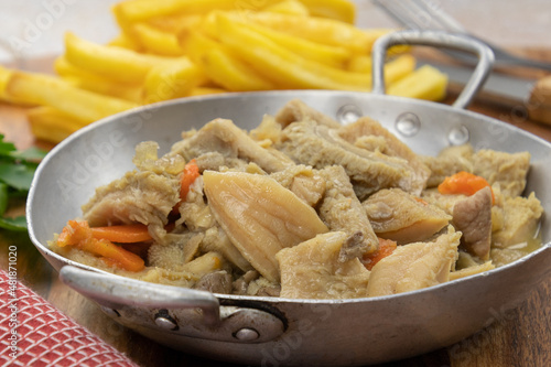 dish of tripe and fries on a table	