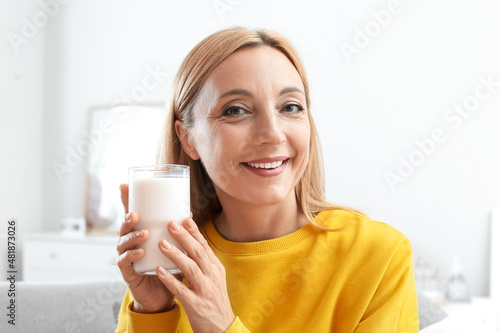 Mature woman with glass of ...