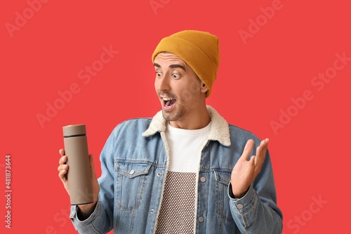 Surprised man with thermos ...