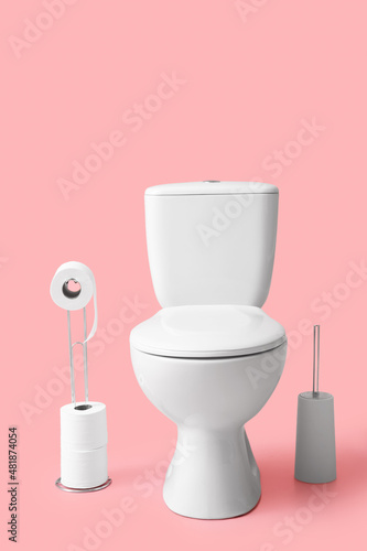 Bilde på lerret Holder with rolls of paper, toilet bowl and brush on color background