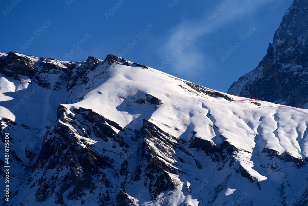 Swiss Alps with downhill slope of famous Lauberhorn Ski Race on a sunny winter morning. Photo taken January 15th, 2022, Wengen, Switzerland.