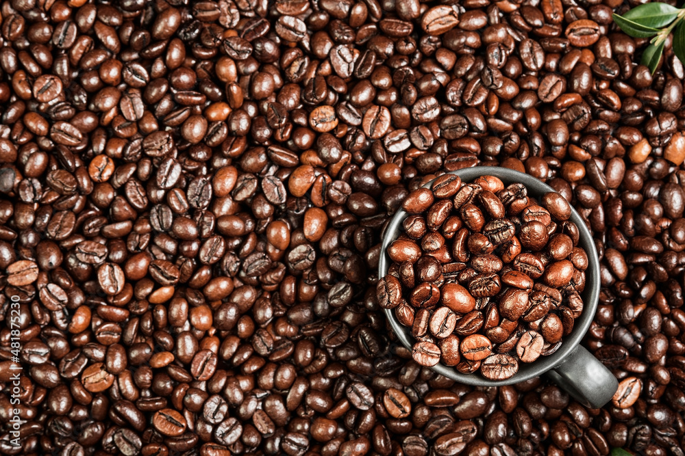 Fototapeta premium Coffee background with space for text, layout of coffee beans on the table and black cup for espresso coffee, coffee advertising idea