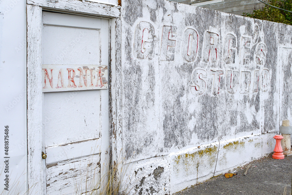 exfoliating paint on old wall and door with letters , Kent, Oregon, USA