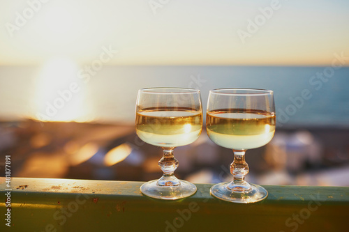 Two glasses of white wine with Atlantic coast beach in background