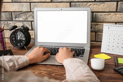 Woman working with laptop a...