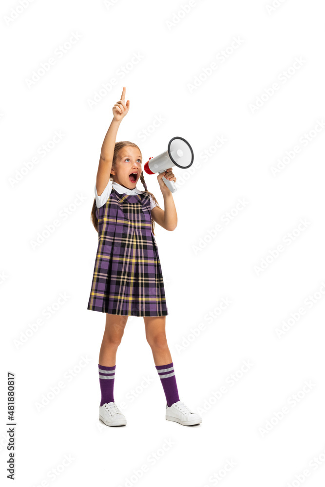 Portrait of cute child, little girl, pupil in school uniform posing isolated on white background. Concept of childhood, emotions, study Portrait of cute child, little girl, pupil in school uniform posing isolated on white background. Concept of childhood, emotions, study