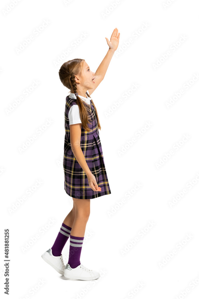 Portrait of cute child, little girl, pupil in school uniform posing isolated on white background. Concept of childhood, emotions, study Portrait of cute child, little girl, pupil in school uniform posing isolated on white background. Concept of childhood, emotions, study