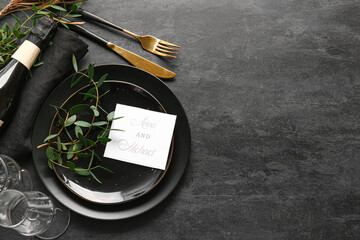 Beautiful table setting with wedding invitation on black background