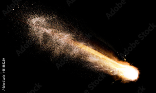 texture of a falling comet with sparks, smoke and a trail of particles, isolated on a black background