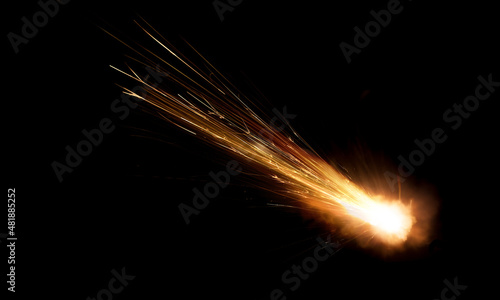 texture of a falling comet with sparks, smoke and a trail of particles, isolated on a black background
