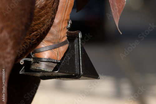 Detail of the spur, stirrup and boot of a Doma Vaquera rider